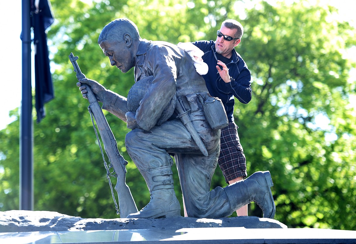 David Kraszewski of the Flathead Marines polishes the life and quarter Veterans Memorial sculpture in Depot Park on May 20 in Kalispell. The monument is polished, the grounds cleaned up and the bricks are strengthened and leveled in advance of Memorial Day. The United Veterans of the Flathead Valley Memorial Day ceremony will begin at 11 a.m. at Depot Park followed by the VFW Post 2252 luncheon in Kalispell.