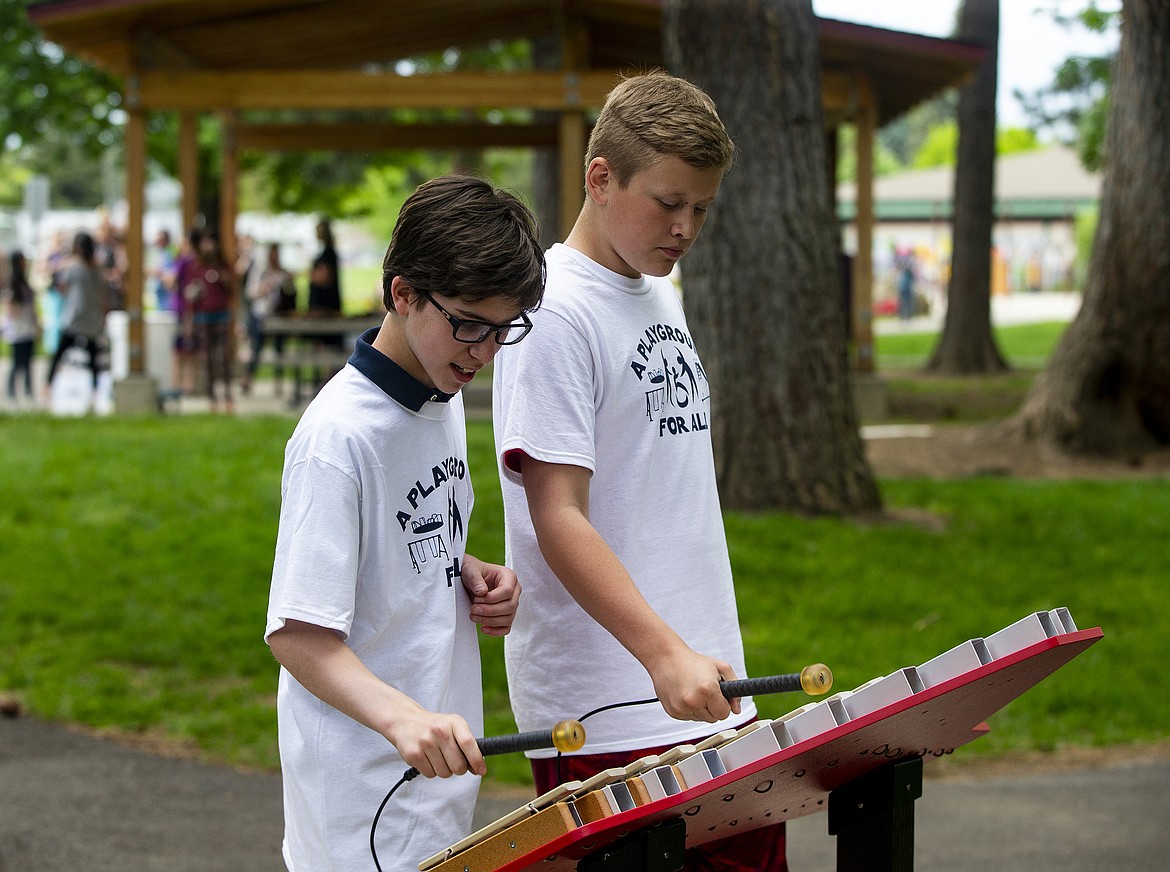 Seventh-graders Paden Parsiot, left, and Alex Green play a tune on a Xylophone Wednesday afternoon at Fernan Elementary's new Playground For All. (LOREN BENOIT/Press)