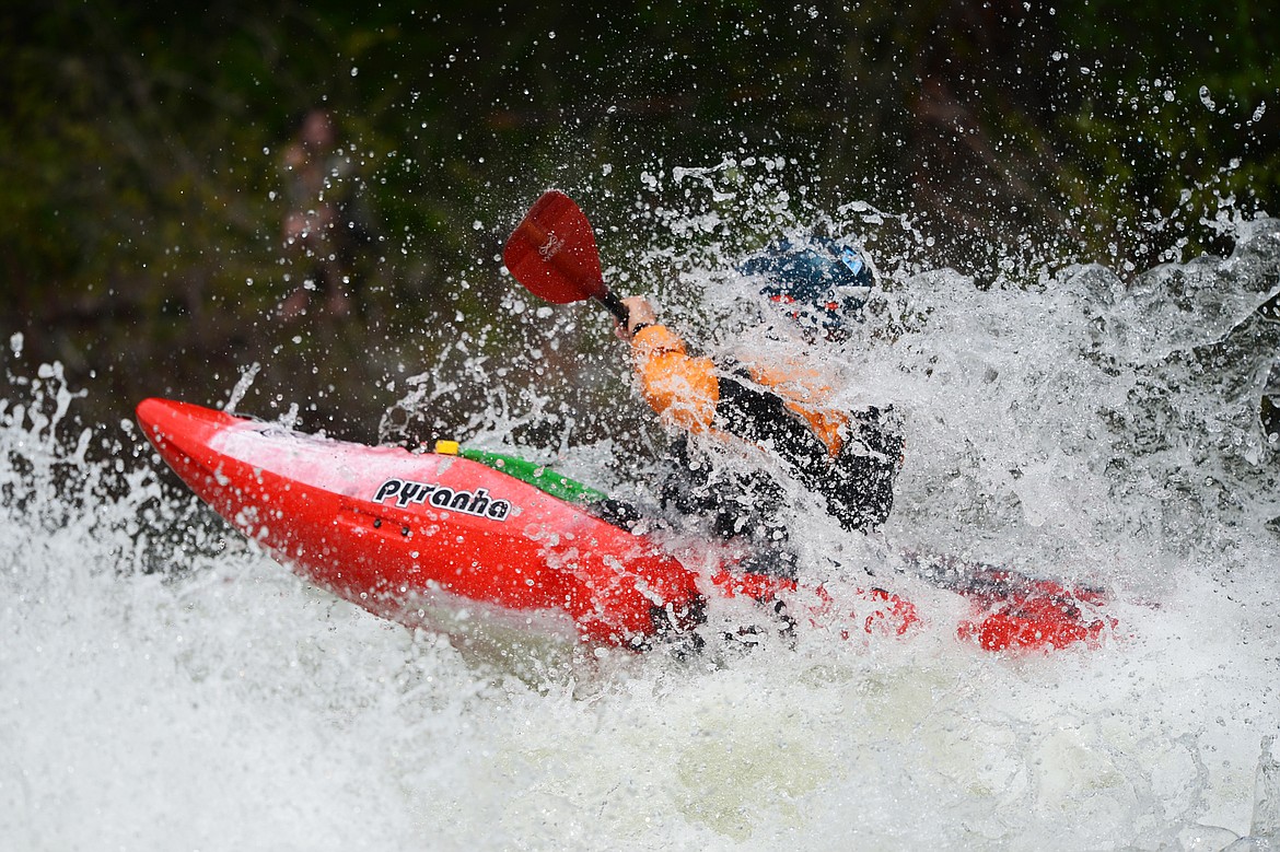 Kayakers navigate the Swan River during the Expert Slalom event at the Bigfork Whitewater Festival in Bigfork on Saturday. (Casey Kreider/Daily Inter Lake)