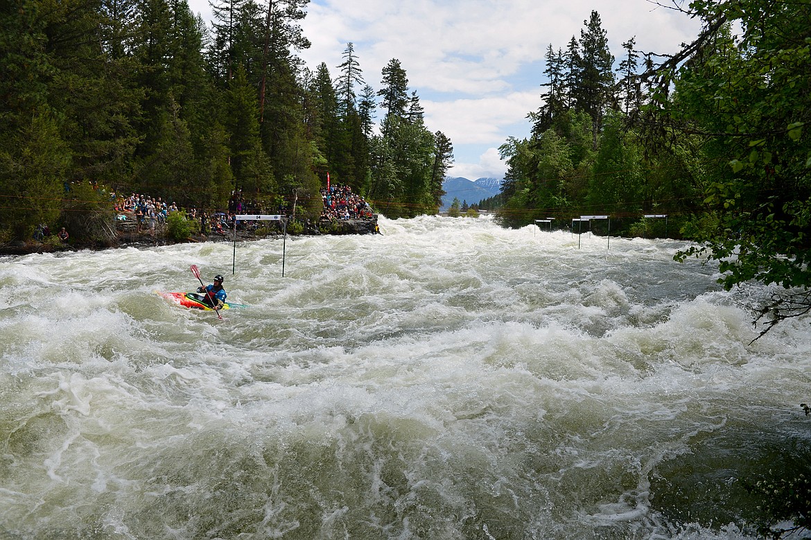 Kayakers navigate the Swan River during the Expert Slalom event at the Bigfork Whitewater Festival in Bigfork on Saturday. (Casey Kreider/Daily Inter Lake)