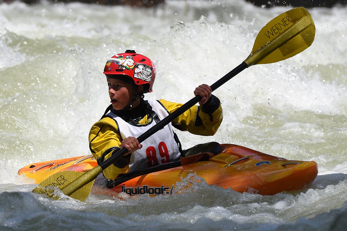 Kayakers navigate the Swan River during the Expert Slalom event at the Bigfork Whitewater Festival in Bigfork on Saturday. (Casey Kreider/Daily Inter Lake)