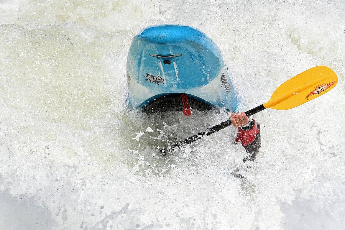 Kayakers navigate the Swan River during the Expert Slalom event at the Bigfork Whitewater Festival in Bigfork on Saturday. (Casey Kreider/Daily Inter Lake)