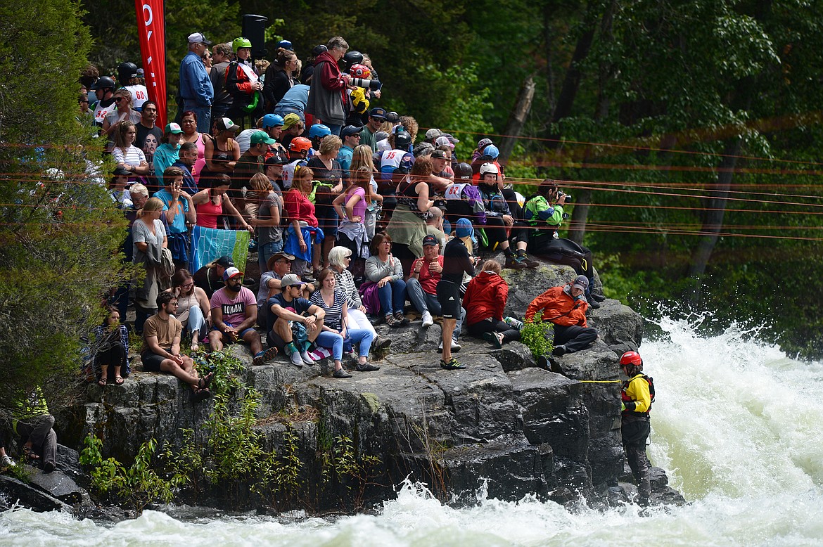 People gather on The Large Rock to watch the action at the Bigfork Whitewater Festival in Bigfork on Saturday. (Casey Kreider/Daily Inter Lake)