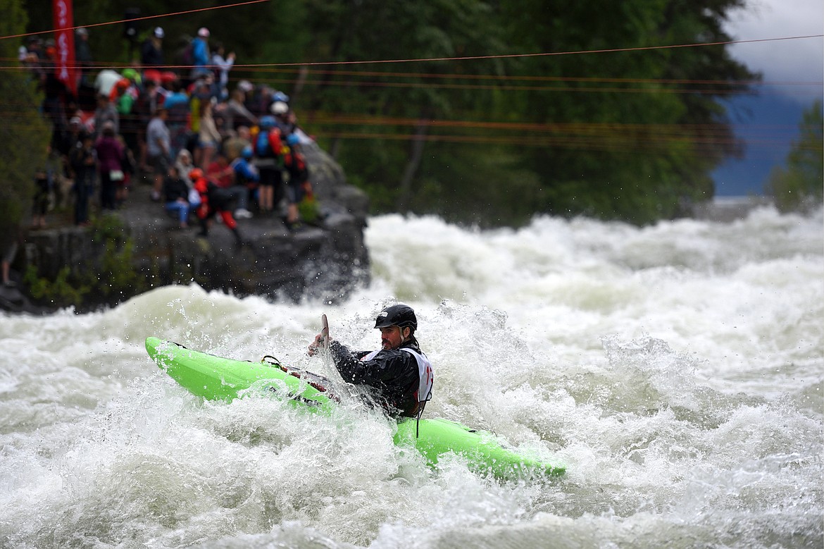 Kayakers navigate the Swan River during the Expert Slalom event at the Bigfork Whitewater Festival in Bigfork on Saturday. (Casey Kreider/Daily Inter Lake)