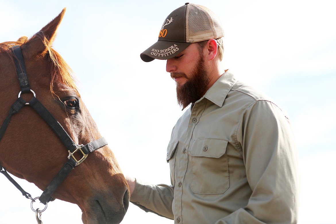 Veteran Jim Vincent, of Kalispell, works with Molly on a warm Saturday morning at Ranch &#145;M under the direction of counselor Natalie Norrell of Medicine Horse Center. (Mackenzie Reiss/Daily Inter Lake)