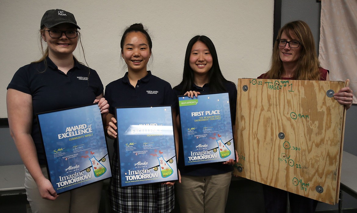 With the encouragement of science teacher Kiera Beck, pictured at right, North Idaho Christian School sophomores Jennika Bettis, Anna Cho, and Cathy Ko won first place in the multi-approach category of the McKinstry Built Environment Challenge at Imagine Tomorrow last weekend. (JUDD WILSON/Press)