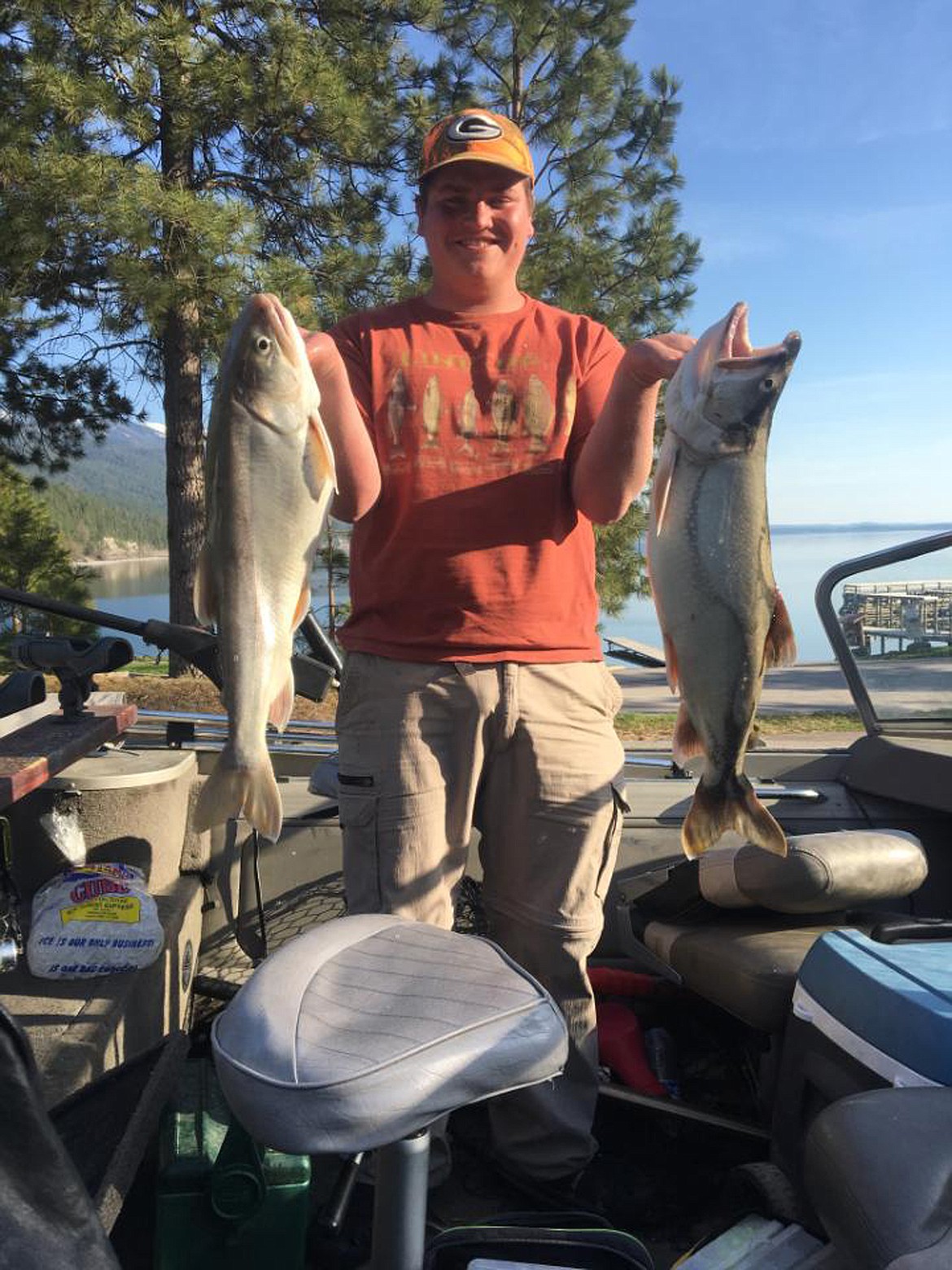 TYLER VARGA shows off a pair of lake trout he caught on Flathead Lake while he and his father, Ken, competed in the Mack Days Fishing Event. Varga won the 13-17 age group with 794 fish. (Photo from Ken Varga)