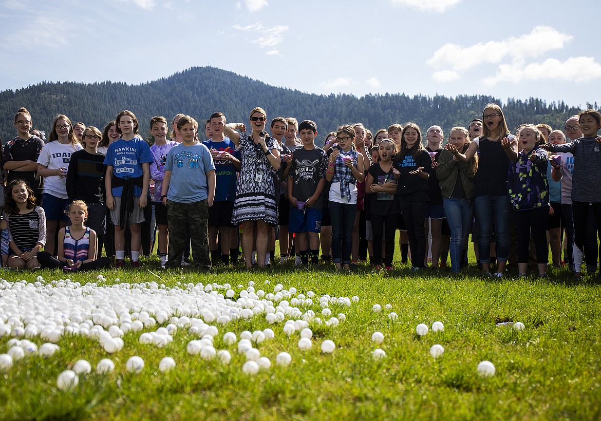 LOREN BENOIT/Press
Canfield Middle School students watch 2,500 ping pong balls dropped from a 45-foot crane by their principal, Nick Lilyquist, outside the school Monday morning. The ping pong balls were sold for $5 each, for a PTA fundraiser. Only students who sold balls were invited to watch the drop while eating snow cones. Prizes were awarded for the balls which landed closest to and farthest from the hole, as well as the top sellers from each class.