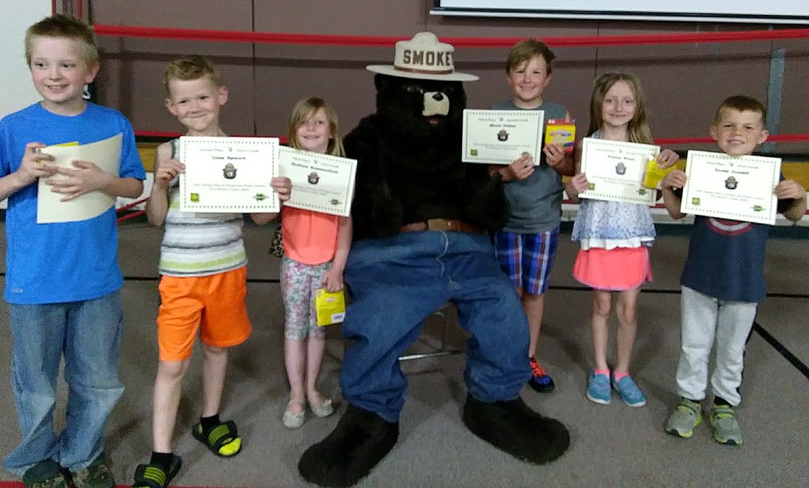 (Courtesy photo)
SmokeyBear and Woodsy poster contest winners at Idaho Hill Elementary get their photo taken with Smokey Bear last week as he visited the school to talk about wildfire prevention.