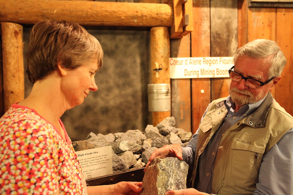 At the Museum of North Idaho, Dorothy Dahlgren and Robert Singletary examine a silver-lead-galena ore specimen from Lucky Friday Mine. (Photo by DUANE RASMUSSEN)