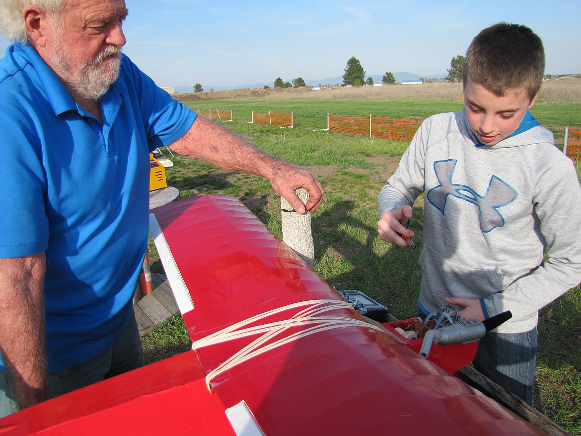 Don Blaine prepares a plane for flight on the Rathdrum Prairie, with his grandson, Jamison Brunner.