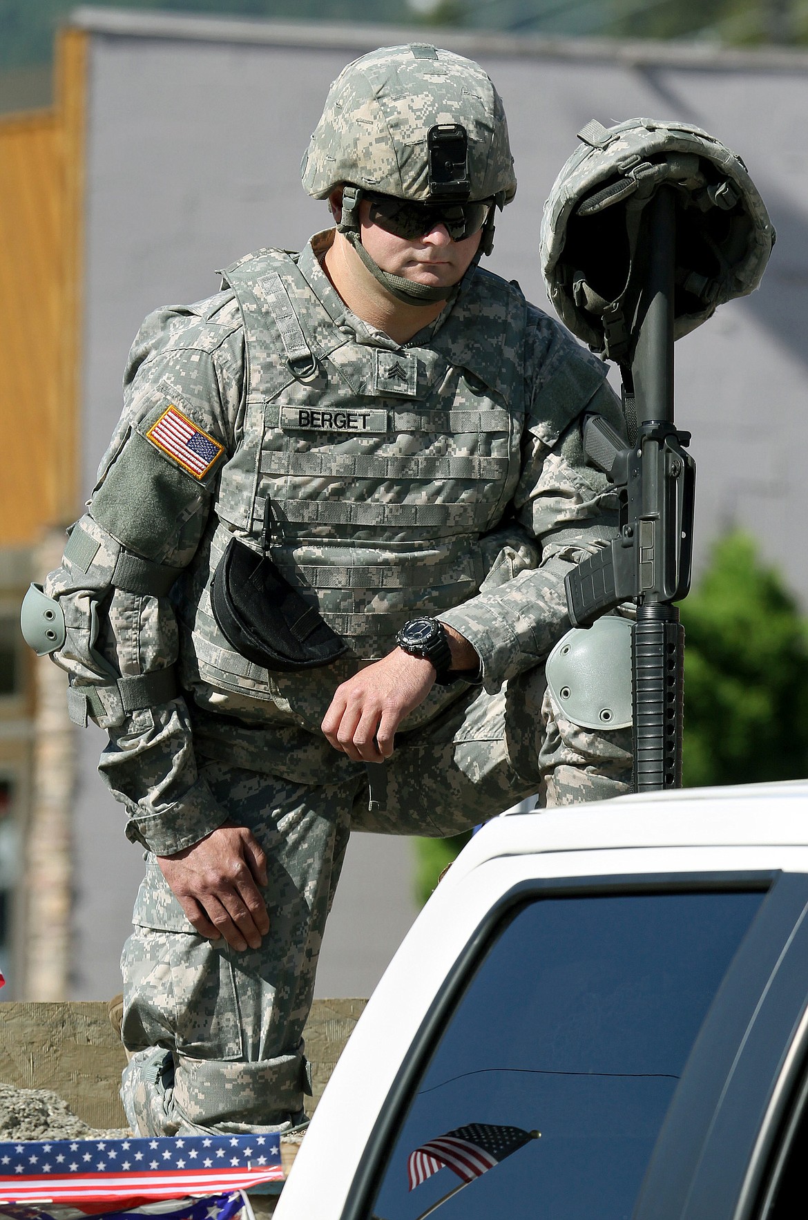 Sgt. Charles Berget, Unit Supply NCO for the 639th CSC Det1, the local National Guard Armory, pays his respects to fallen soldiers while riding in the Wounded Warrior Memorial Day parade on Mineral Avenue in Libby Sunday. “Memorial day to me is honoring those who served before me, and secured the freedoms we sometimes take for granted,” he said. (John Blodgett/The Western News)