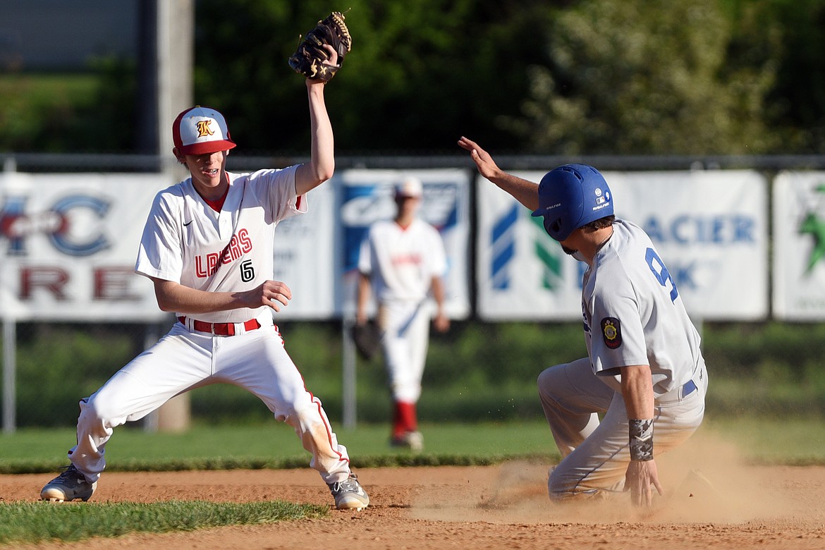 Libby's Tim Carvey steals second base as Kalispell Lakers B second baseman McKade Schara can't handle the throw. (Casey Kreider/Daily Inter Lake)