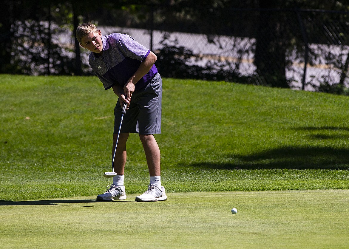 Taylor Bush of Kellogg watches his putt on the 14th green at the state 3A tournament.
