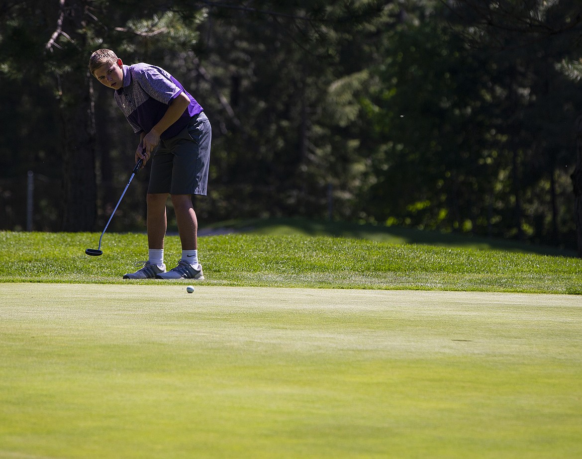 Taylor Bush of Kellogg High watches his putt on the 15th green at the state 3A tournament.