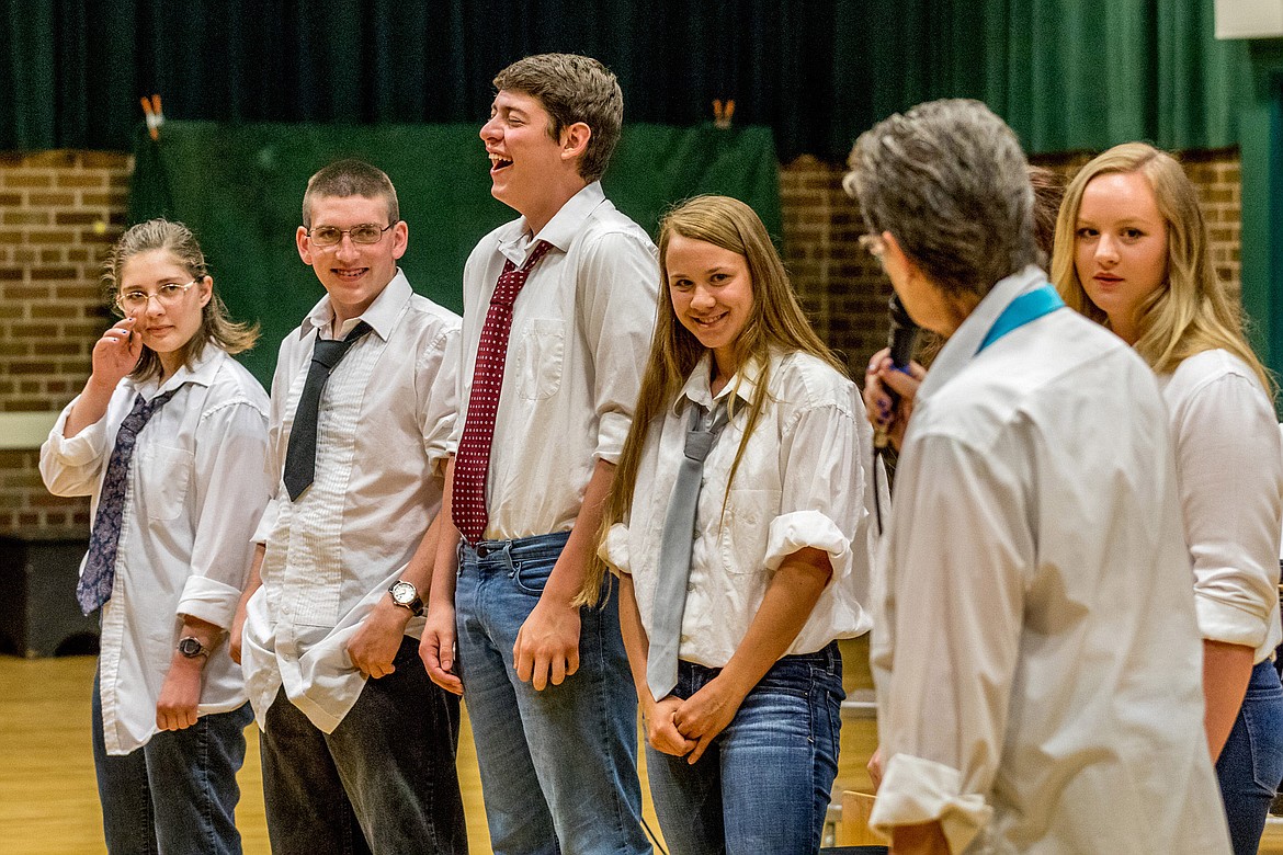 Choir Director Lorraine Braun, second from right, honors Libby High seniors who sang in choir during an end-of-school-year event at Libby Memorial Events Center Tuesday evening. Pictured from left are Christina Corbell, Nate Wisdom, Hunter Muzi, Isabelle Martineau, Arianna Willis (obscured by Braun) and Laurynn Lauer. “My director’s gift to them is a pillow and a batch of their favorite cookies,” Braun said. (John Blodgett/The Western News)