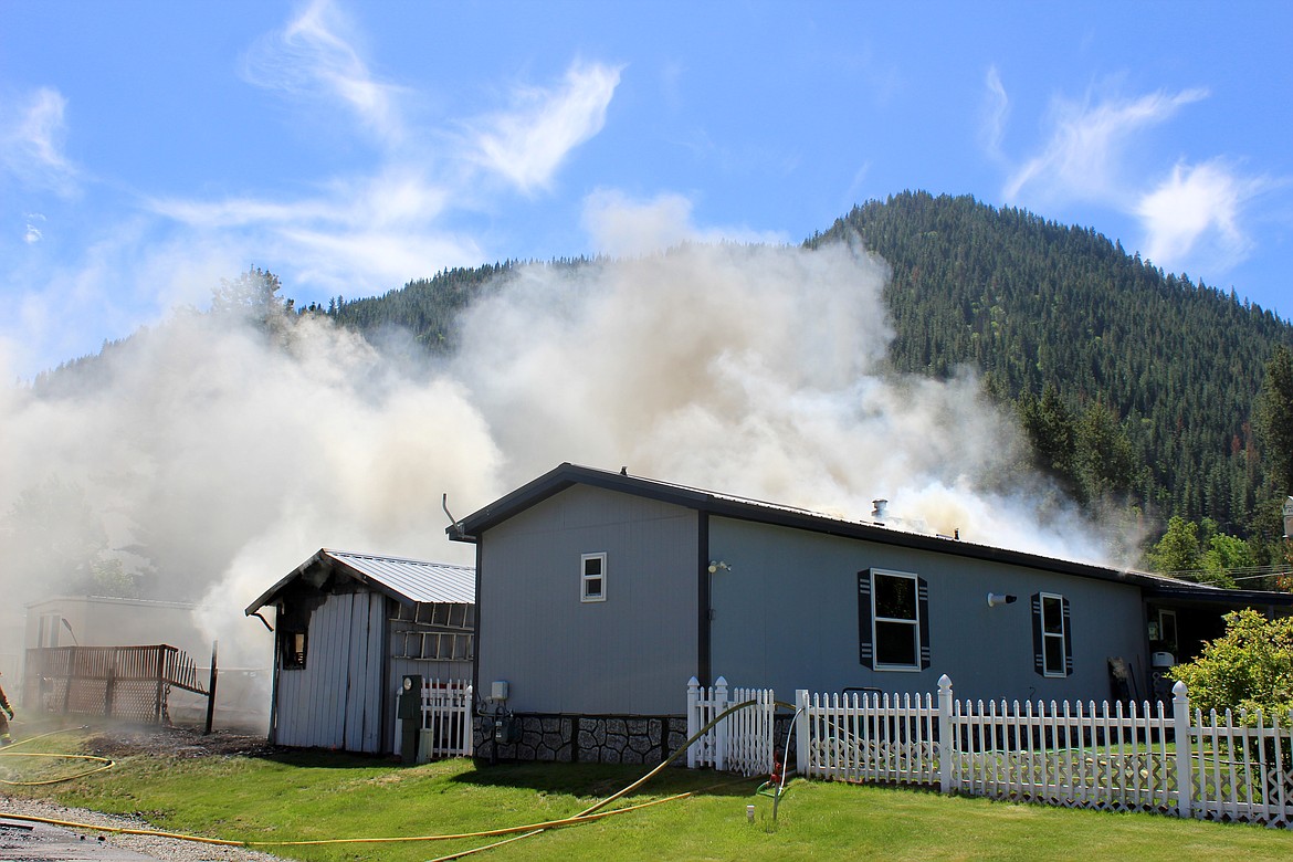 A wide shot of the home and garage from the Northwest.