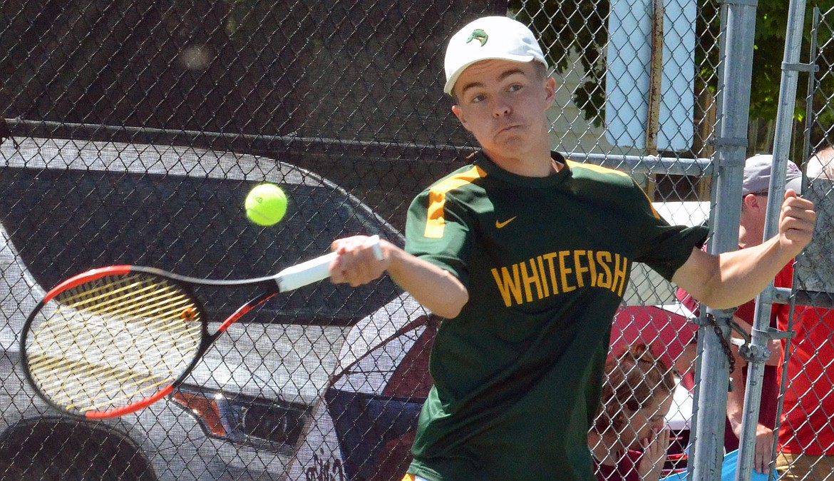 Brendan Buls makes a return during his Class A state tennis tournament singles semifinal match with Manuel Gonzalez of Butte Central in Polson on Friday. (Jason Blasco/Lake County Leader)