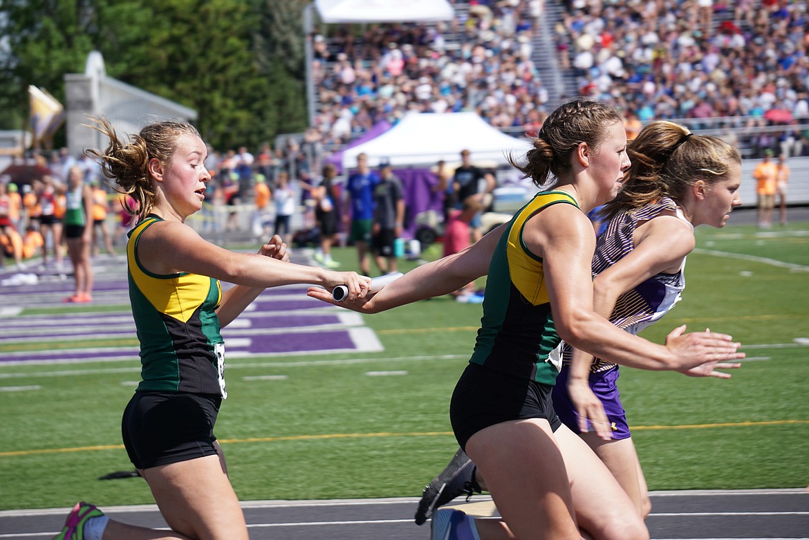 Bulldog Lydia Kryshak passes the baton to teammate Annie Robertson in the 4x100 meter relay at the Class A state track meet. (Photo courtesy Matt Weller)