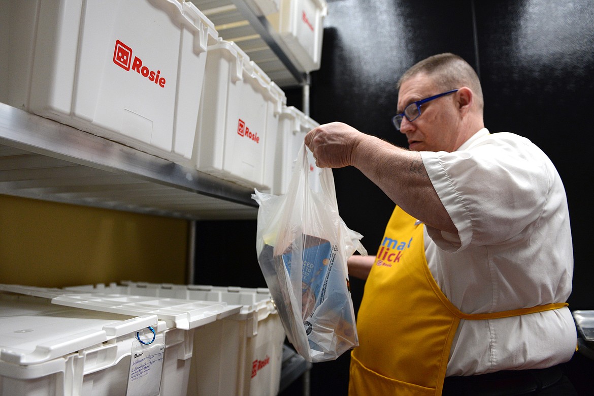 George Tyler places items from a Super 1 Smart Click order into a bin for a customer at Super 1 Foods in Kalispell on Thursday, May 10. (Casey Kreider/Daily Inter Lake)