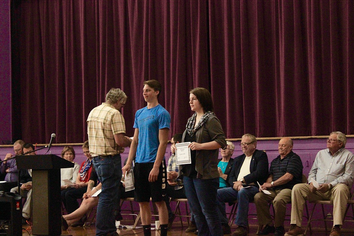 Photo by  LILA HILEMAN/ Mullan seniors Terran Dykes and Tony Hernandez receive an Elks Club Scholarship from Elks Representative and MHS Math Teacher Ben Clark at.