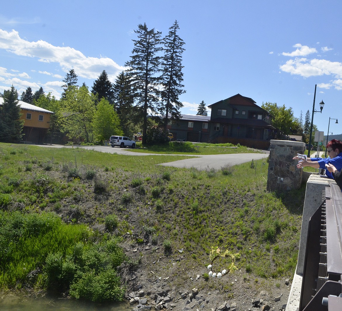 A wreath is dropped into the Whitefish River from the Veteran Memorial Bridge Monday afternoon during the annual Memorial Day parade. (Heidi Desch/Whitefish Pilot)