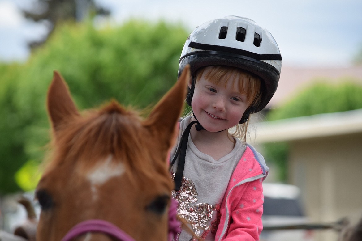 Charles H. Featherstone/Columbia Basin Herald
Five-year-old Eliza Rang rides one of the Grant County Sheriff&#146;s Posse&#146;s horses as people gathered for the autism walk in Ephrata on Saturday.