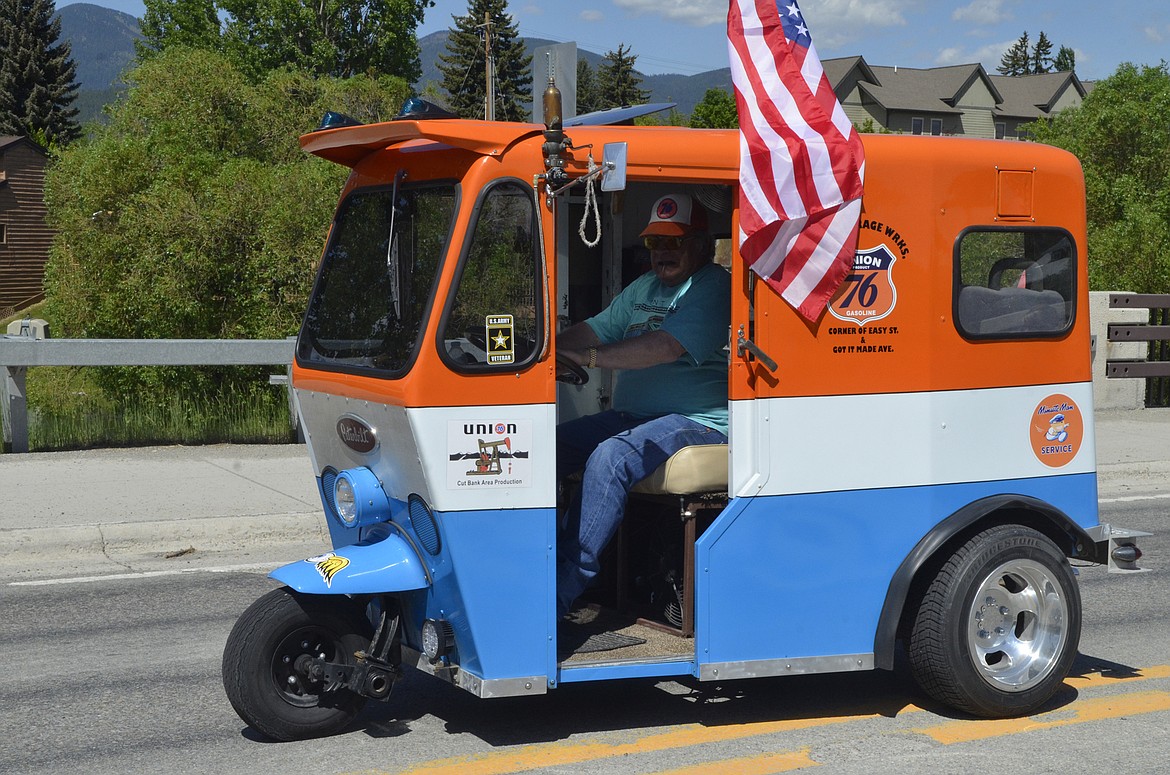 A vehicle drives in Monday afternoon in the Memorial Day parde down Second Street. (Heidi Desch/Whitefish Pilot)