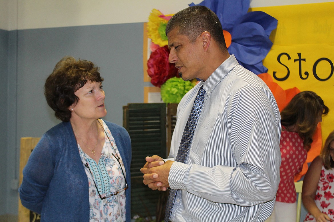 Cheryl Schweizer/Columbia Basin Herald
Laurel Skaug talks with Garden Heights principal Abe Ramirez during a retirement party Thursday for Skaug and two other longtime teachers.