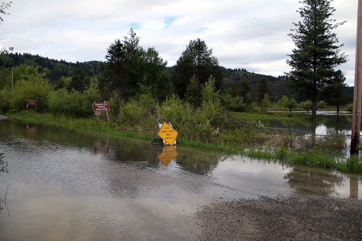 (Photo by MARY MALONE)The Priest River rose up across a private property and flooded across Lower Quartz Creek Road and into Peninsula Road, next to the Green Owl Tavern.