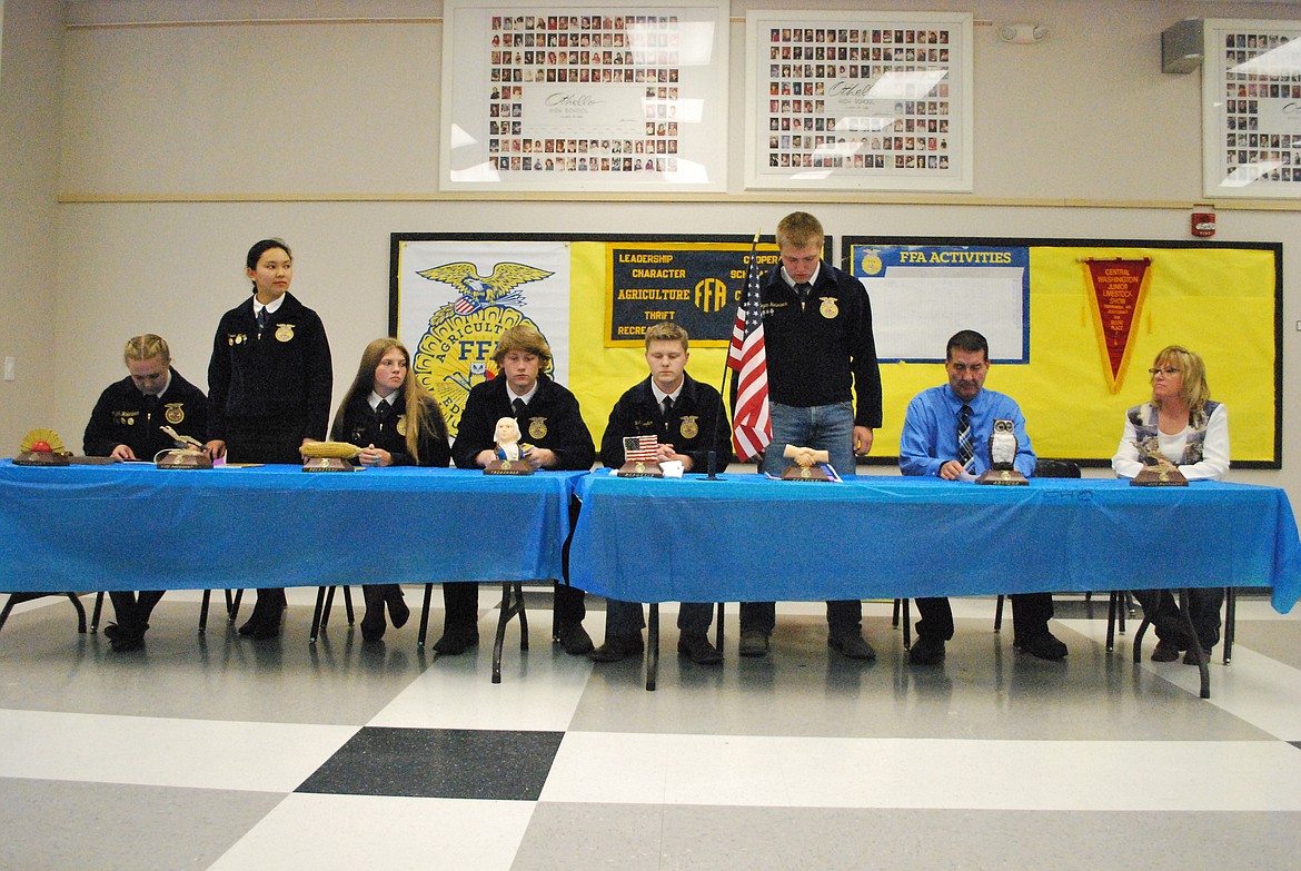 Bob Kirkpatrick/The Sun Tribune - Othello FFA President Mykiah Hollenbeck and Vice President Sarah Wilson present a plaque to guest speaker Kirk Jungers.