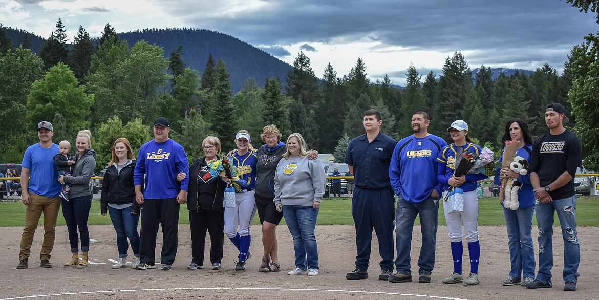 Lady Logger seniors Haylee Cannon and Khalyn Hageness are honored with their families at senior night before Libby beat Columbia Falls 8-6 in their final home game of the season. Not pictured is senior manager Kenna Slinkard, who was absent due to a family event.