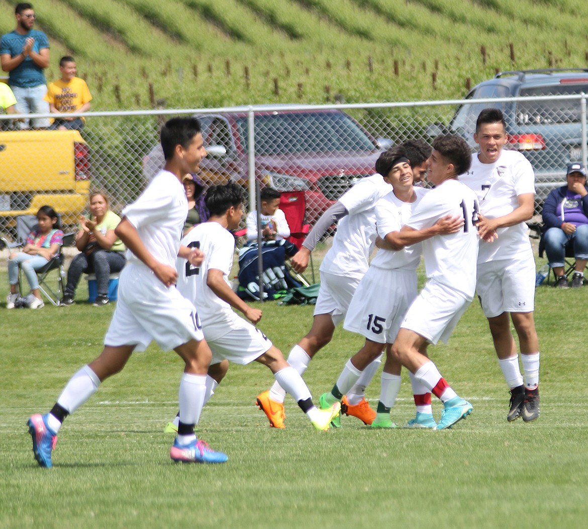 Bob Kirkpatrick/The Sun Tribune - Warrior teammates celebrate Yerik Arellano&#146;s (15) second goal of the match that put Wahluke up 4-0.