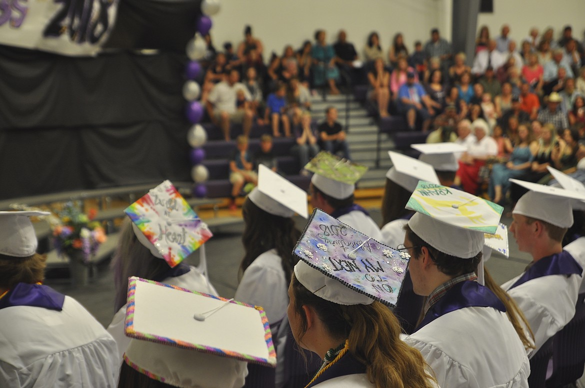 CHARLO GRADUATES don their decorated caps for graduation Sunday in the high school gymnasium. (Ashley Fox/Lake County Leader)