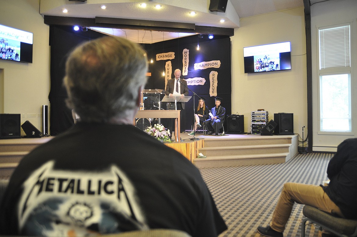 RANDY ADCOCK, a Mission Valley Christian Academy teacher known as &#147;Mr. A.&#148; to students, wears a Metallica T-shirt during graduation as a friendly joke with one of the students. (Ashley Fox/Lake County Leader)