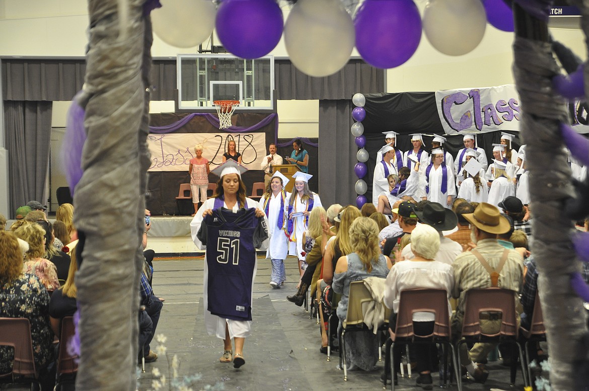 CHARLO SENIOR Sakoya Gaustad carries the retired jersey of fellow classmate Brett Krantz, who passed away in July 2015 following a car accident. The 2018 Charlo class has remembered Brett since his passing, also with each classmate stopping to give father Max a hug after the ceremony. (Ashley Fox/Lake County Leader)