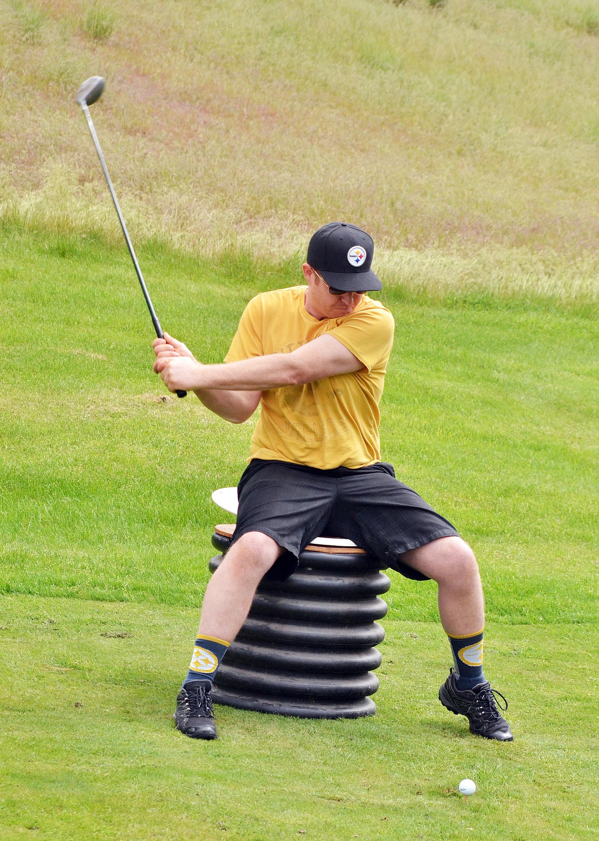 Tyson Bowman of Missoula sits to drive off No. 1 during the Hack and Blast. (Erin Jusseaume photos/ Clark Fork Valley Press)