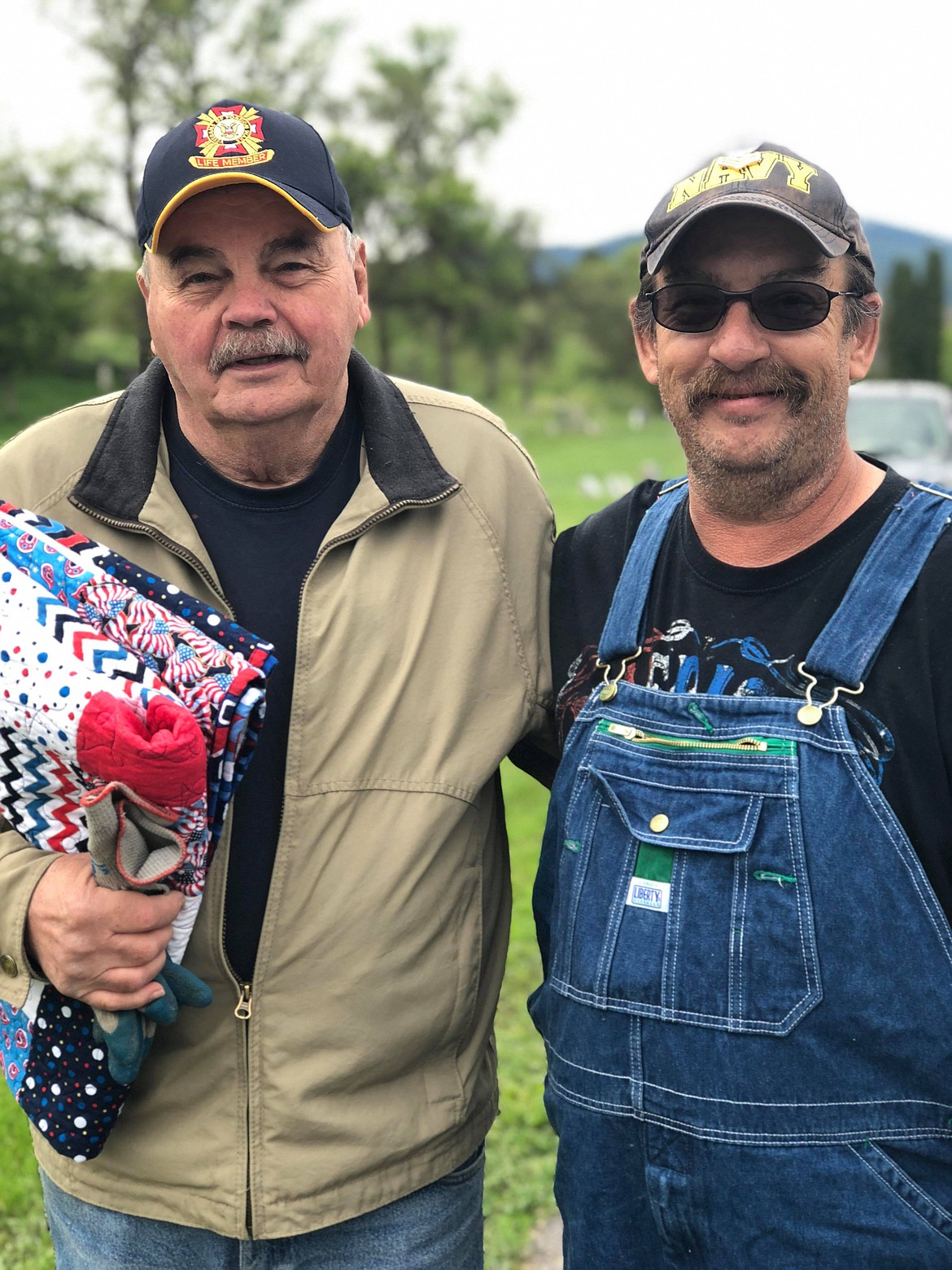 Bill Beck (left) is presented a Quilt of Valor from Joint Operations of Mariposa representative and fellow Veteran Ed Foste.