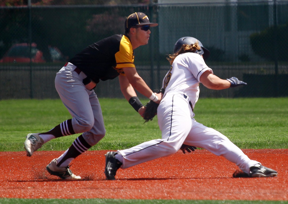 Rodney Harwood/Columbia Basin Herald
Moses Lake second baseman Zack Valdez tags out Mead runner Dalen Simbler (16) during a rundown in the first round of the state tournament at Jackson Field at Shadle Park High School in Spokane on Saturday.