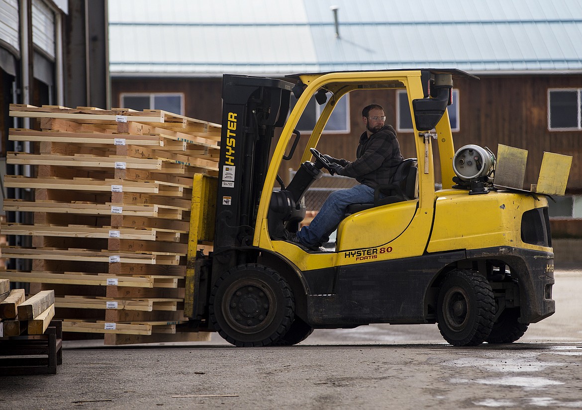 Photos by LOREN BENOIT/NIBJ
Forklift operator Mike Freeman moves pallets at Custom Building and Supply in Post Falls. Most of Custom Building Supply customer orders include pallets, which are used to transport heavy materials and metals.