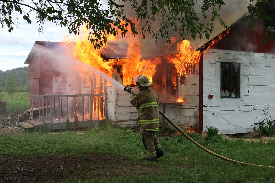 Photo by MANDI BATEMAN
At the end of the day the site was cleaned up and the house was burned down under the watchful eyes of many firefighters, who kept the surrounding trees and bushes safe by keeping them doused with water.