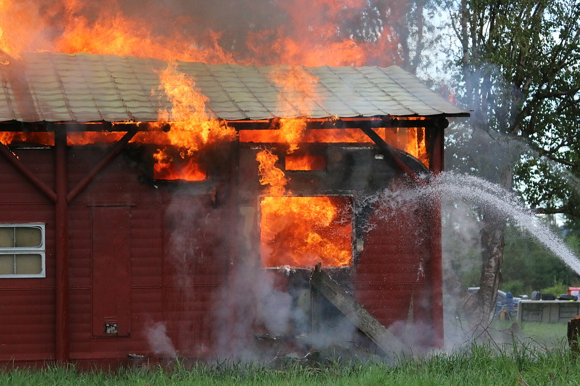 Photo by MANDI BATEMAN
Firefighters kept the blaze under control to safely burn down the house after the training was over.