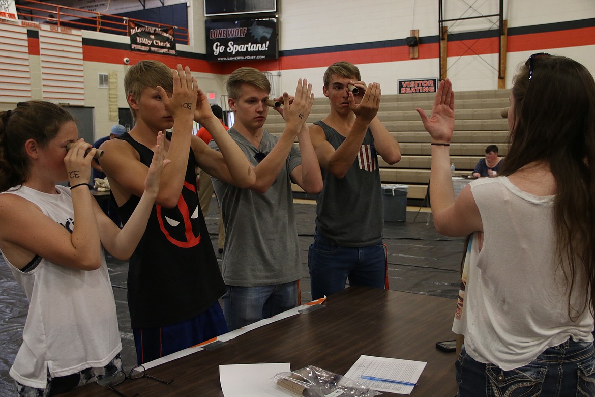 (Photo by MARY MALONE)
Priest River Lamanna High School students, from left, Annika Rantala, Caleb Gleason, Jordan Wayne Phillips and Cameron Parkes learn about dominant eye and tunnel vision during the STEaM Olympics at PRLHS on May 23.