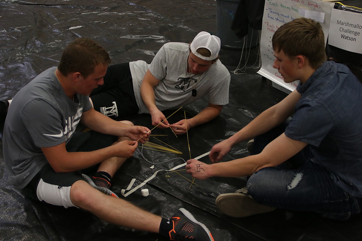 (Photo by MARY MALONE)
Some STEaM Olympics competitors attempt the marshmallow challenge, which included trying to build the tallest free-standing tower of spaghetti noodles that will stay upright when the marshmallow is placed on top.