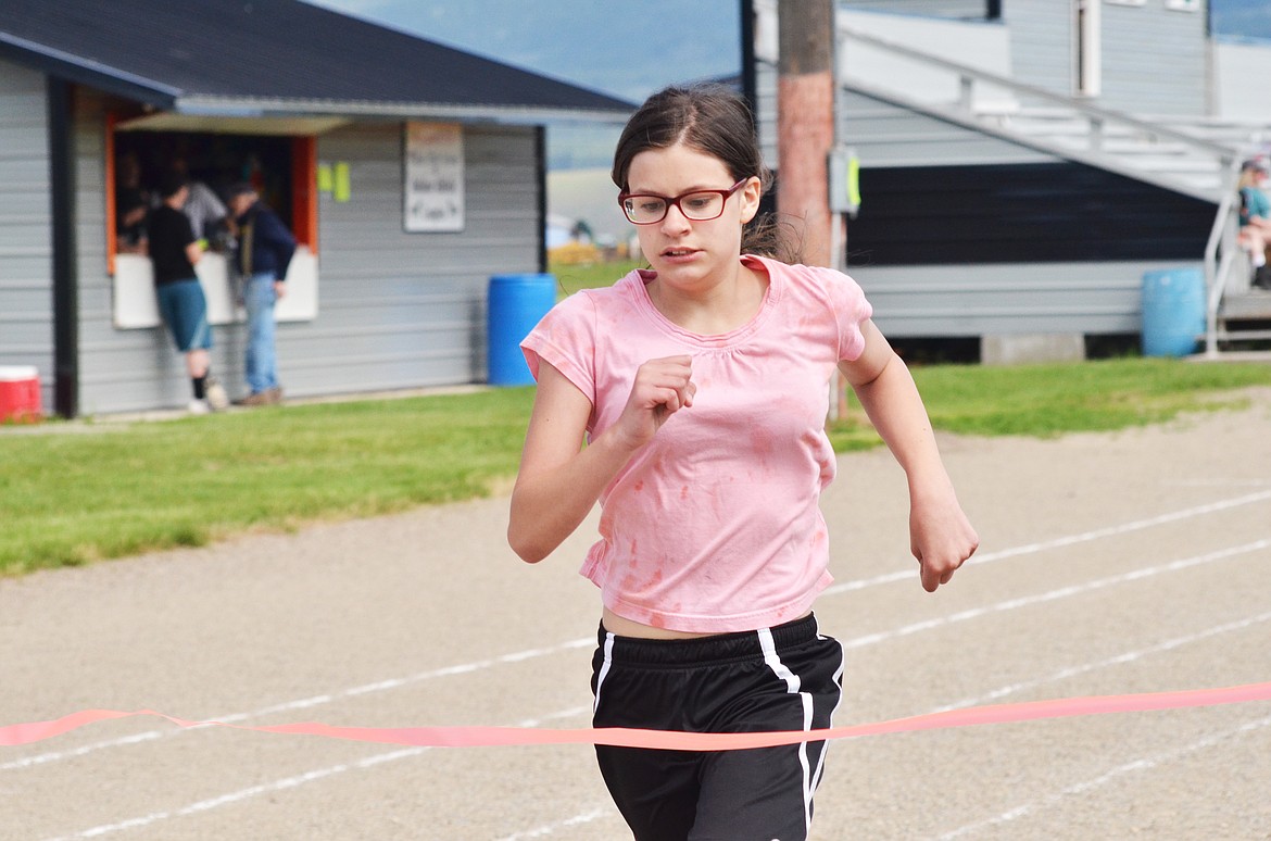 RuBea Privett makes a successful lap around the track as she runs through the ribbon.