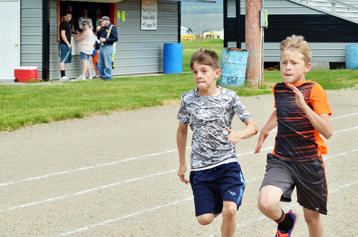 Jacob Lulack(left) races Wyatt Butcher to the ribbon line in a photo finish style as they took part in this years track day (Erin Jusseaume/ Clark Fork Valley Press)