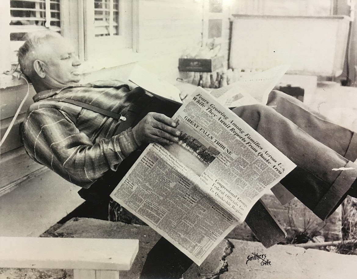 FRED UHDE is pictured relaxing in an adirondack chair as he reads the newspaper. Uhde owned the former general store that once stood in Rollins. (Photo provided courtesy of Peggy Lewis)