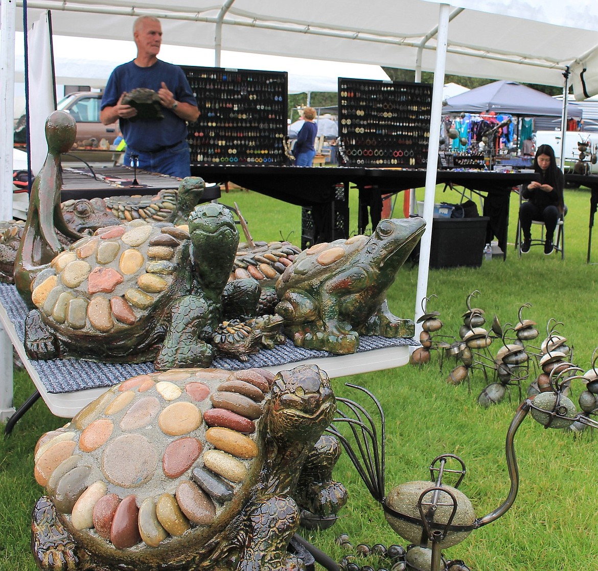 Vendors travel from near and far to attend the St. Regis Flea Market over Memorial Weekend. Don and Rodelie Ross come from Missoula each year to sell jewelry and yard art.