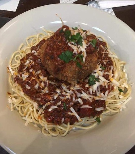 This dish brings the tradition of spaghetti with a twist as it is served with a large mozzarella stuffed meatball and topped with Parmesan cheese.