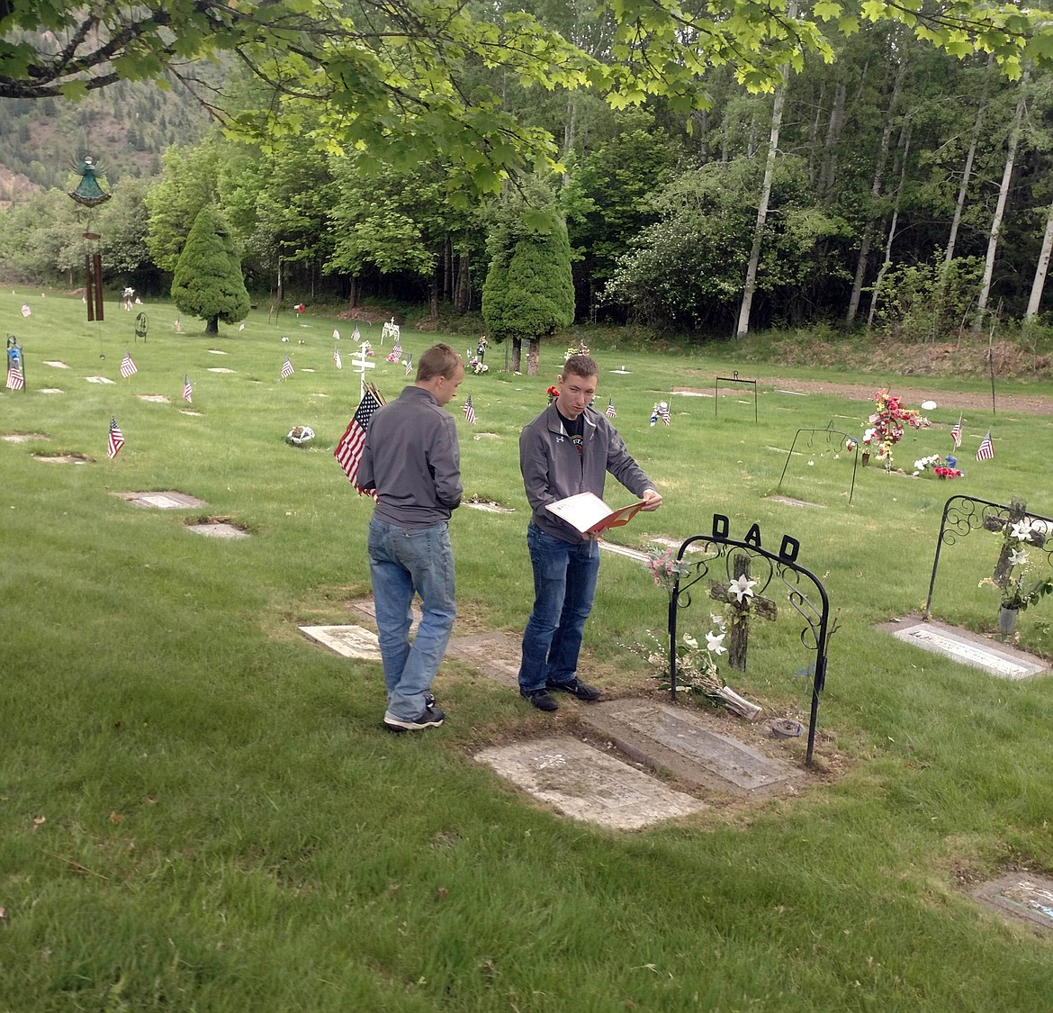 Students checking each headstone to make sure that no fallen veterans are missed as they place flags.